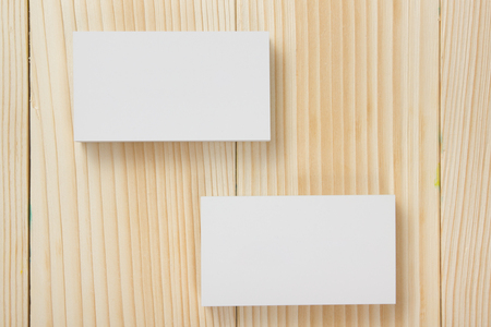 Blank white business cards on wood background.の写真素材