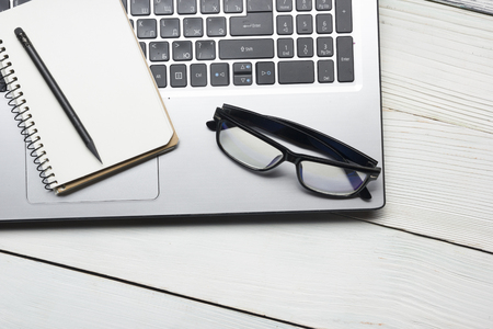 Office desk table with supplies and glasses. Top view. Copy space for text.の写真素材