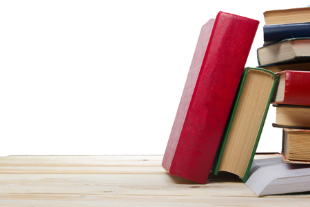 Stack of books on wooden shelf isolated on white background. Back to school. Copy space for text.の写真素材