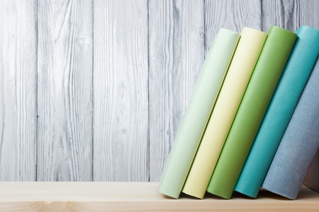 Stack of books on wooden table. Back to school. Copy space.の写真素材