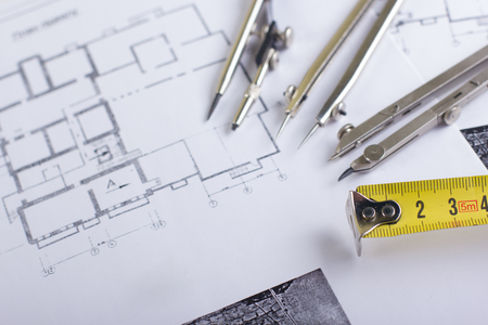 Workplace of architect - Architectural project, blueprints, rolls and tablet, pen, divider compass...