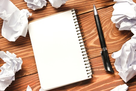 Office desk table with supplies and crumled paper. Top view. Copy space for text.の写真素材