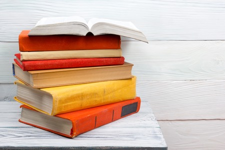 Open book, hardback books on wooden table. Back to school. Copy space.の写真素材