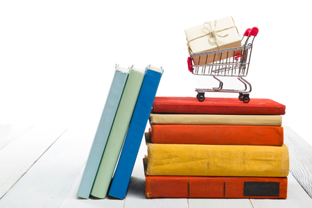 Stack of books on wooden shelf isolated on white background. Back to school. Copy space for text.の写真素材