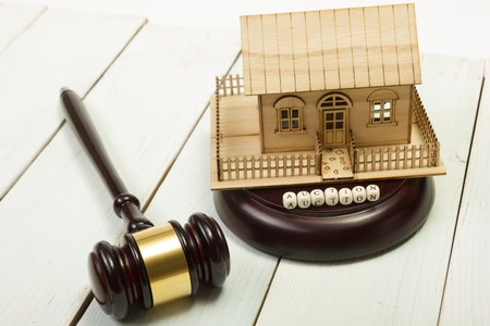 Auction. Law. Miniature House on wooden table and Court Gavel.の写真素材