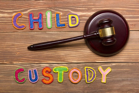 Judge gavel and colourful letters regarding child custody, family law conceptの写真素材