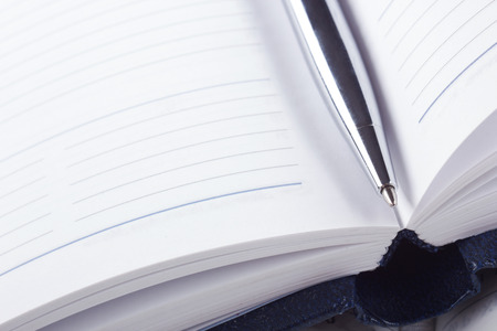 Close-up of open book and pen. Macro viewの写真素材