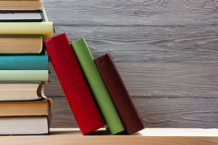 Stack of books on wooden table. Back to school. Copy space.の写真素材