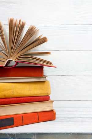 Open book, hardback books on wooden table. Back to school. Copy space.の写真素材
