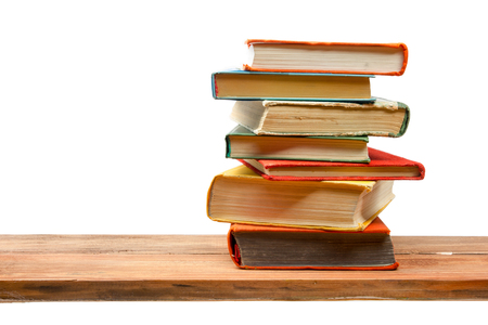 Stack of books on wooden shelf isolated on white background. Back to school. Copy space for text.の写真素材