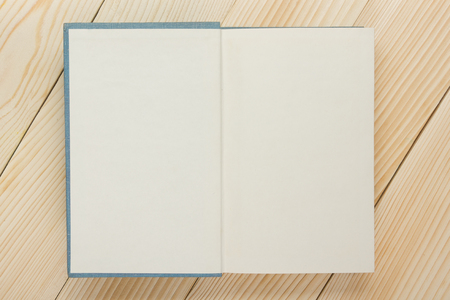 Open book with blank pages on textured wood background. Copy space.の写真素材