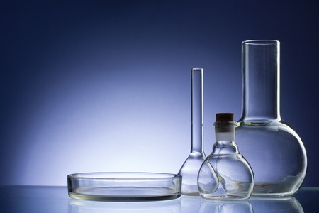 Assorted empty laboratory glassware, test-tubes. Blue tone medical background. Copy space for textの写真素材