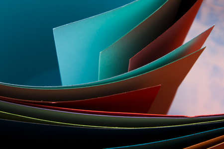 Macro image of colorful curved sheets of paper. Abstract background