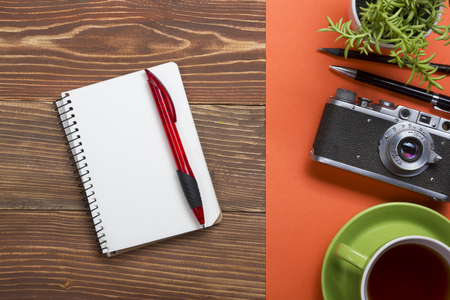 Travel,  vacation concept. Camera and supplies on office wooden desk table. Top view with copy space for text.の写真素材
