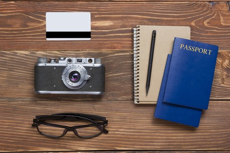 Travel,  vacation concept. Camera and supplies on office wooden desk table. Top view with copy space for text.の写真素材