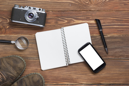 Travel,  vacation concept. Camera and supplies on office wooden desk table. Top view with copy space for text.の写真素材