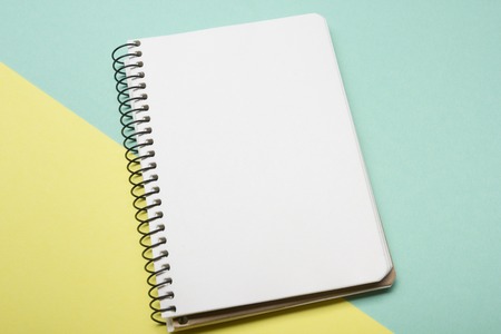 Office desk table with supplies top view. Notepad, pen and colorful paper. Copy space for text.