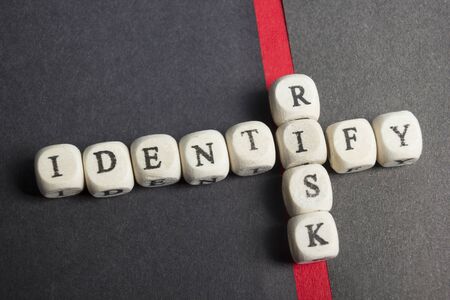 Risk indentify crossword blocks on table. Top view.