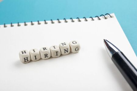 HIRING word written on wood block. Wooden Abc.の写真素材