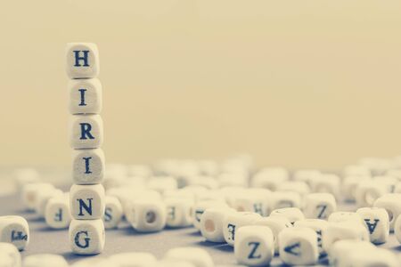 HIRING word written on wood block. Wooden Abc.の写真素材