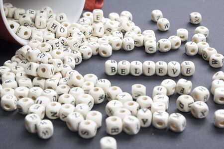 BELIEVE word written on wood block. Wooden ABCの写真素材