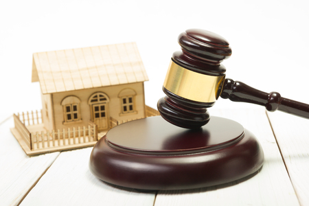 Auction. Law. Miniature House on wooden table and Court Gavel.の写真素材
