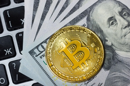 Bitcoin golden coin New virtual money and dollar background . Cryptocurrency. Business and Trading concept. Close-up shotの写真素材