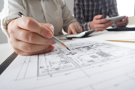 Architects working on blueprint, real estate project. Architect workplace - architectural project,...