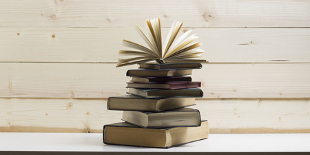 Open book, hardback books on wooden table. Back to school. Copy space