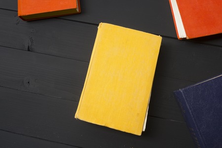 Open book, hardback books on wooden table. Back to school. Copy space.