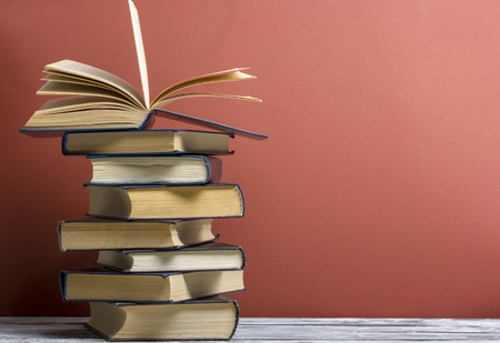 Open book, hardback books on wooden table. Back to school. Copy space