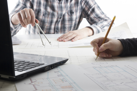 Architects working on blueprint, real estate project. Architect workplace - architectural project,...