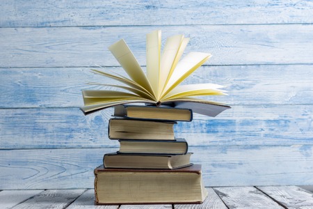 Open book, hardback books on wooden table. Back to school. Copy space