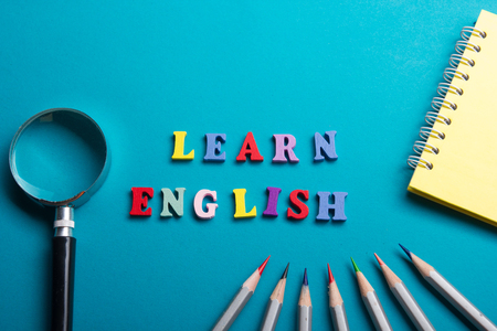 Learn English concept. Time to Learning languages. Word composed from colorful abc alphabet block wooden letters, copy space for ad text.の写真素材