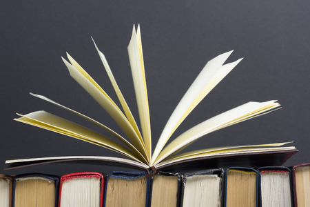 Open book, hardback books on wooden table. Back to school. Copy space.の写真素材