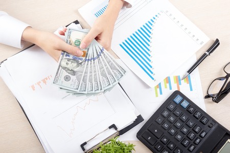 Close up of female accountant or banker making calculations. Savings, finances and economy conceptの写真素材