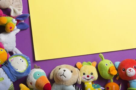 Colorful kids toys frame on wooden background. Top view. Flat lay. Copy space for text.の写真素材