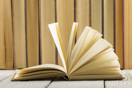 Open book, hardback books on wooden table. Back to school. Copy space