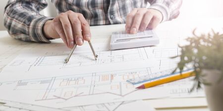 Architects working on blueprint, real estate project. Architect workplace. Construction concept....