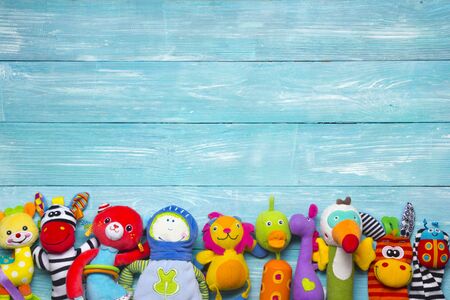 Colorful kids toys frame on wooden background. Top view. Flat lay. Copy space for text.の写真素材
