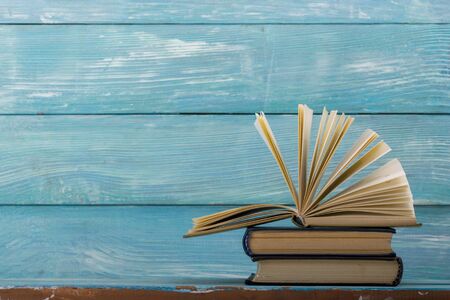 Open book, hardback books on wooden table. Back to school. Copy spaceの写真素材
