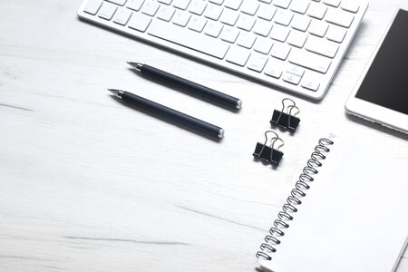 White desk office with laptop, smartphone and other work supplies with cup of coffee. Top view with copy space for input the text. Designer workspace on desk table essential elements on flat layの写真素材