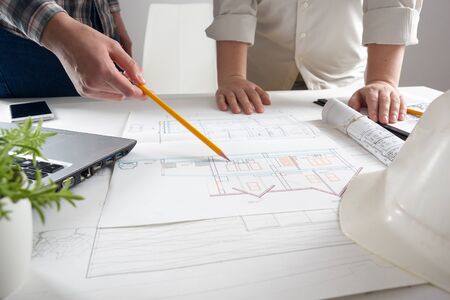 Architects working on blueprint. Architects workplace - architectural project, blueprints, ruler,...