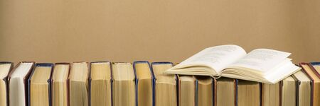 Open book, hardback books on wooden table. Back to school. Copy space.の写真素材