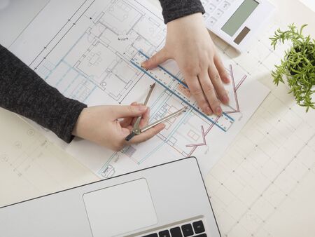 Architects working on blueprint. Architects workplace - architectural project, blueprints, ruler,...