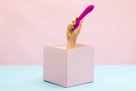 Woman holding Sex toy for adult. Gift box, special offer and sale time conceptの写真素材