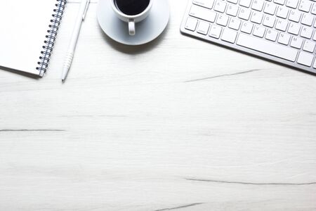 White desk office with laptop, smartphone and other work supplies with cup of coffee. Top view with copy space for input the text. Designer workspace on desk table essential elements on flat layの写真素材