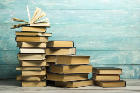 Open book, hardback books on wooden table. Back to school. Copy space.の写真素材
