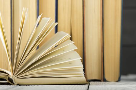 Open book, hardback books on wooden table. Back to school. Copy spaceの写真素材