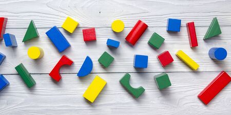 Kids educational developing toys frame on white background. Top view. Flat lay. Copy space for text